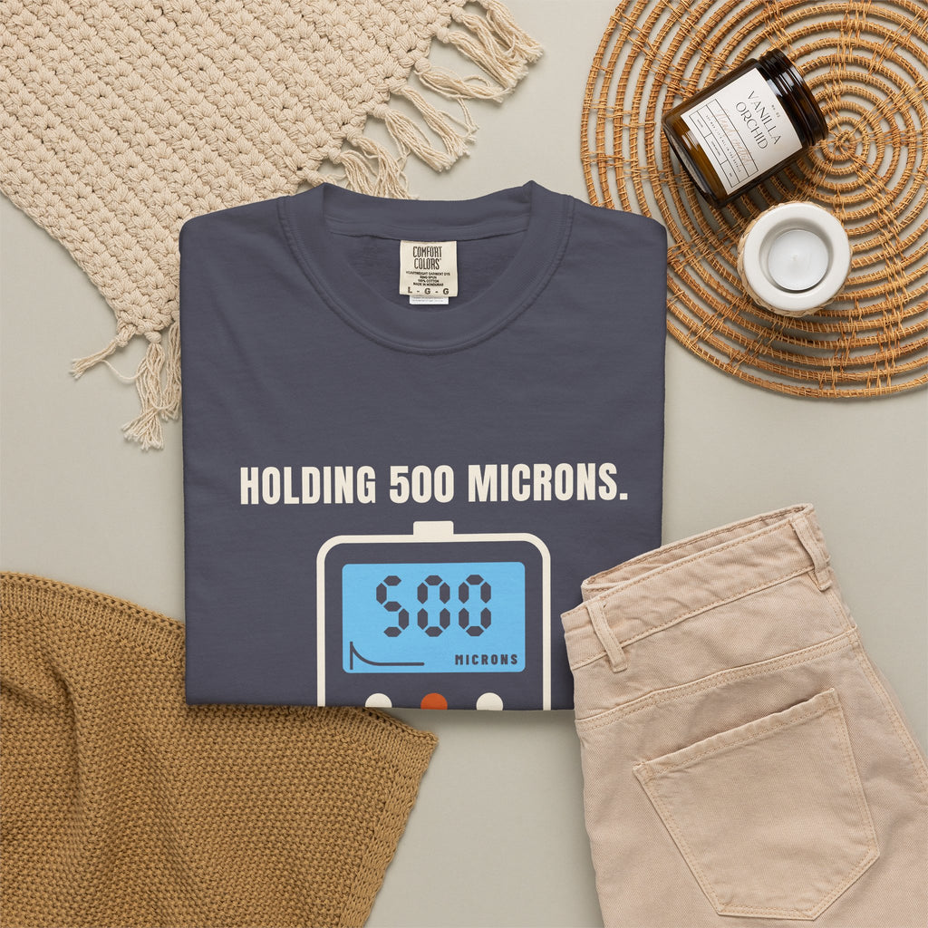 Folded navy t-shirt reading Holding 500 Microns. Unlike My Patience. with a vacuum gauge graphic
