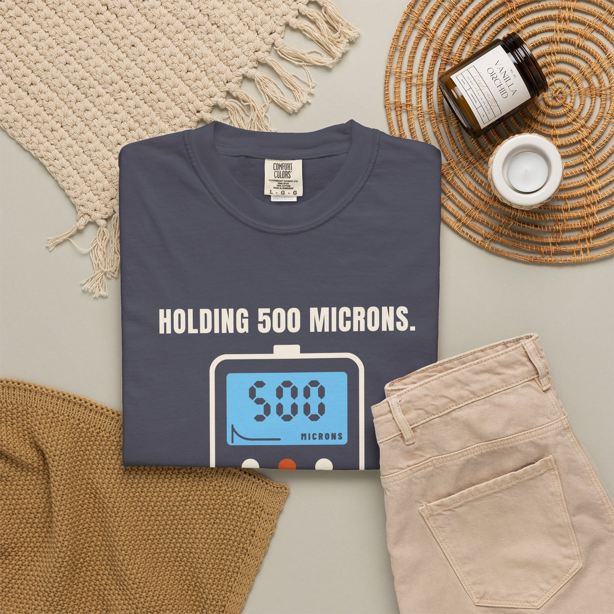 Folded navy t-shirt reading Holding 500 Microns. Unlike My Patience. with a vacuum gauge graphic