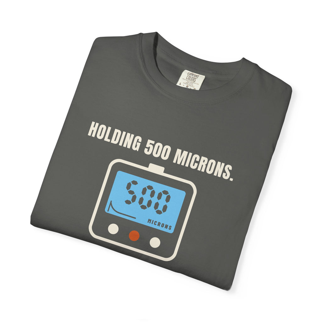 Folded faded black t-shirt reading Holding 500 Microns. Unlike My Patience. with a vacuum gauge graphic
