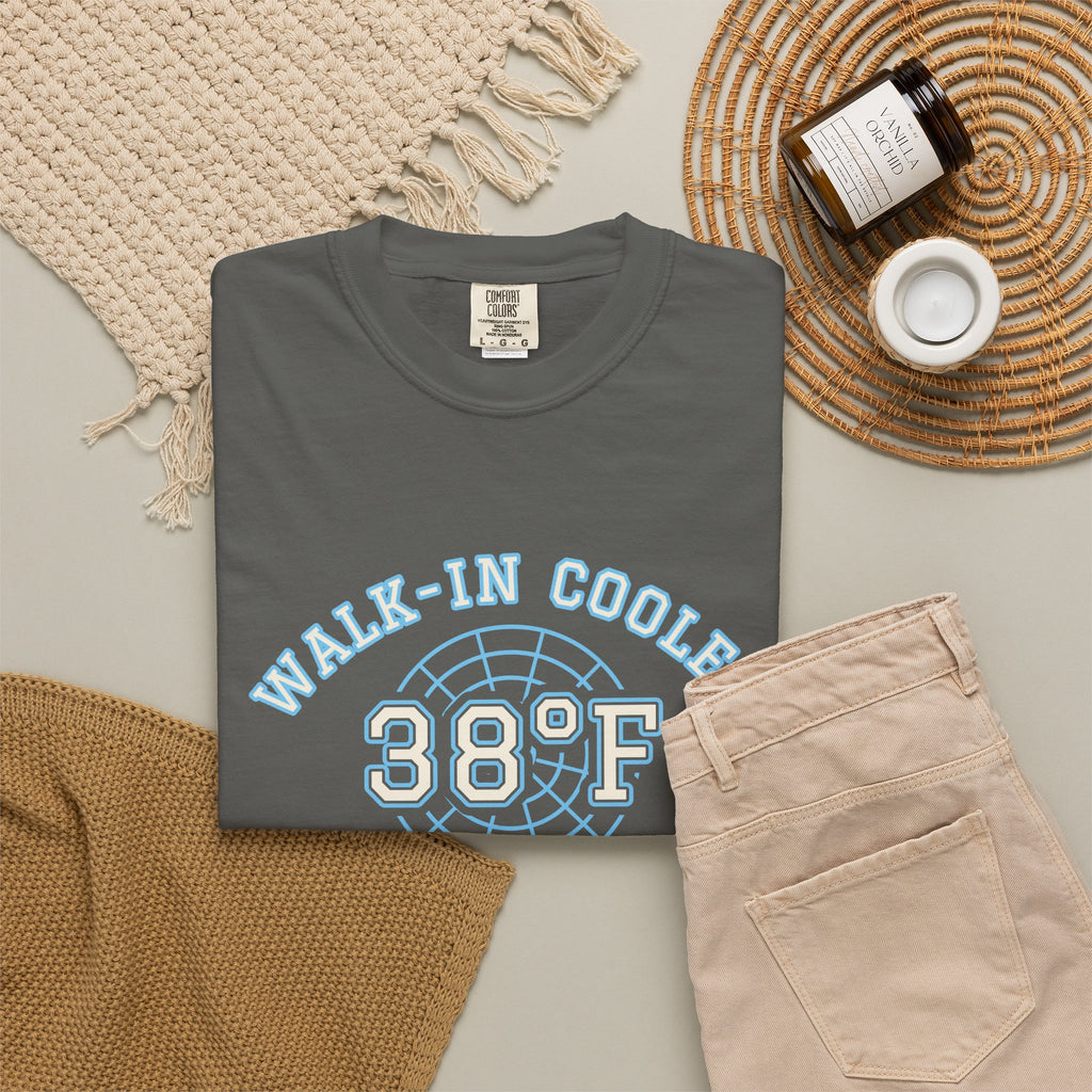 Folded faded black t-shirt with a walk-in cooler door badge reading Walk-In Cooler Crew, Box Temp 38°F