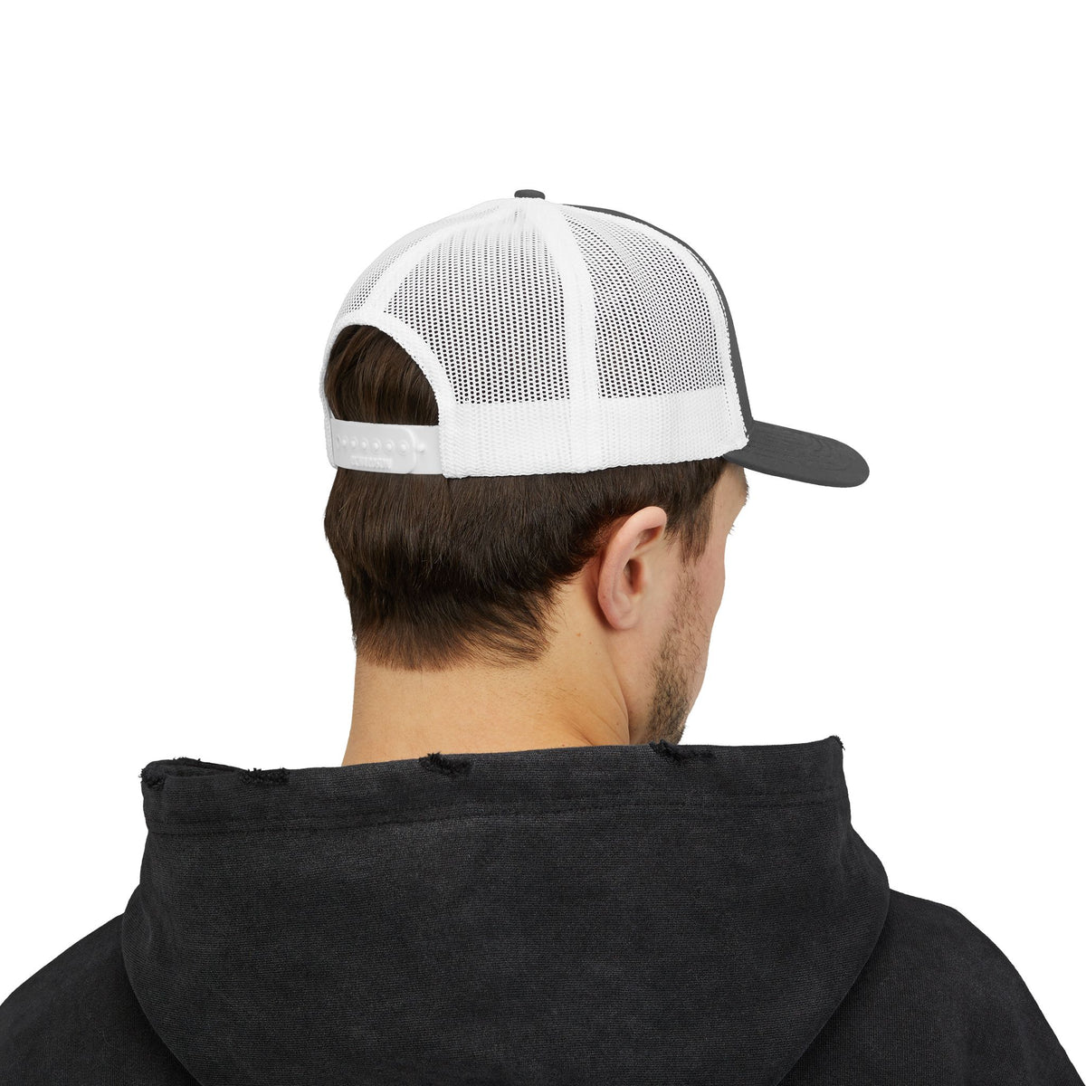 Person wearing the charcoal and white trucker hat, seen from the back with white mesh panels and a snapback