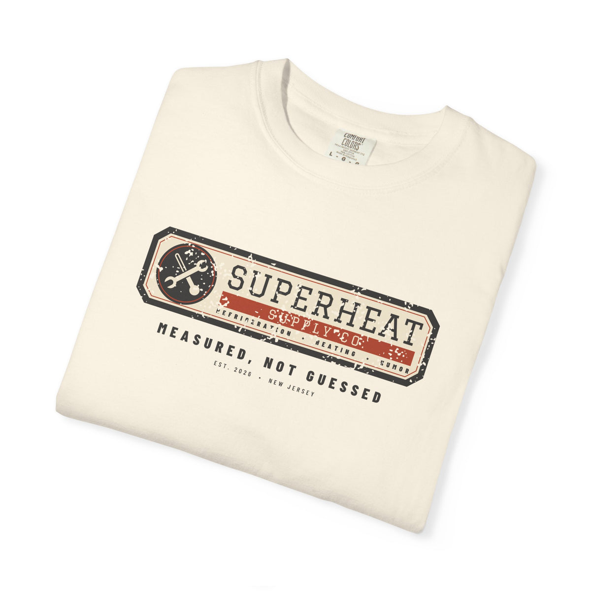 Folded ivory t-shirt with a vintage equipment data plate reading Superheat Supply Co., Refrigeration Heating Humor