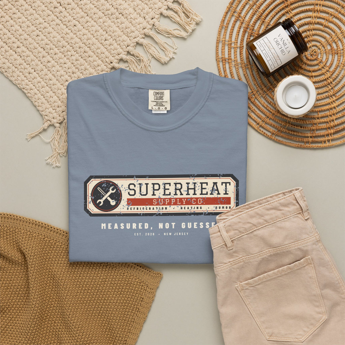 Folded Blue Jean t-shirt with a vintage equipment data plate reading Superheat Supply Co., Refrigeration Heating Humor