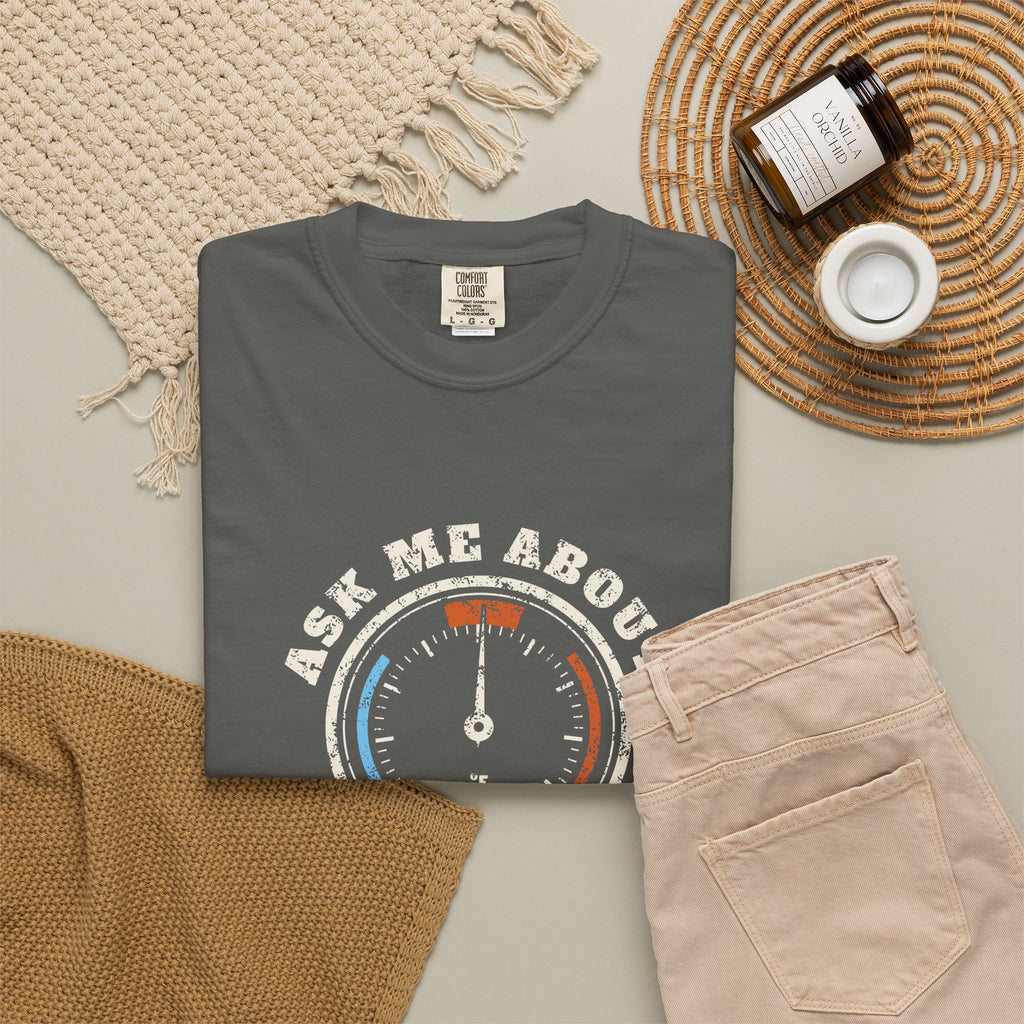 Folded faded black t-shirt with a retro gauge graphic and the words Ask Me About My Superheat across the chest