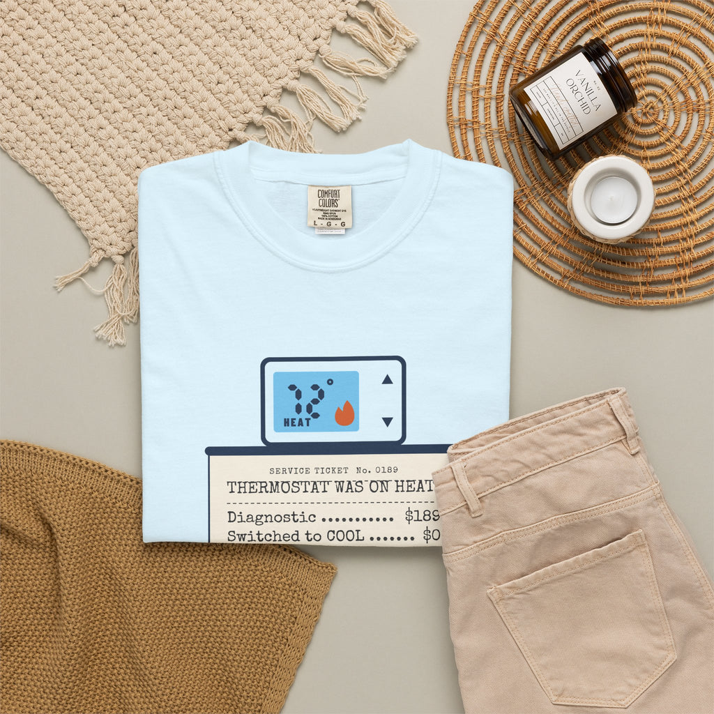Folded Chambray t-shirt reading Thermostat Was on Heat. Diagnosis: $189. with a simple thermostat graphic
