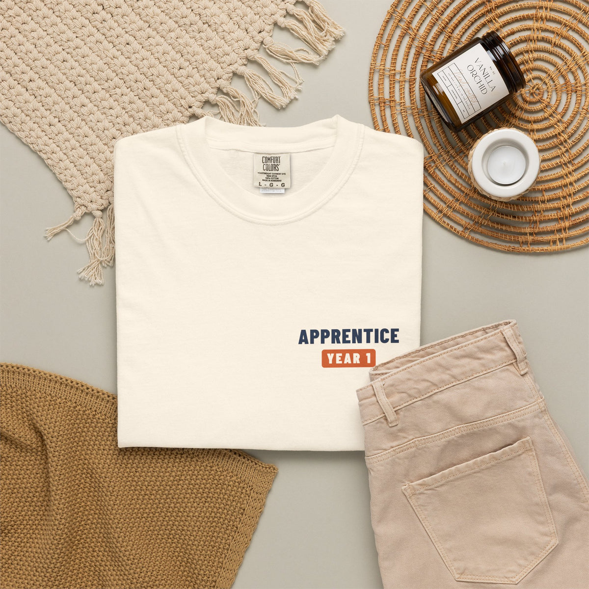 Ivory t-shirt flat-lay with a small Apprentice Year 1 tab on the left chest