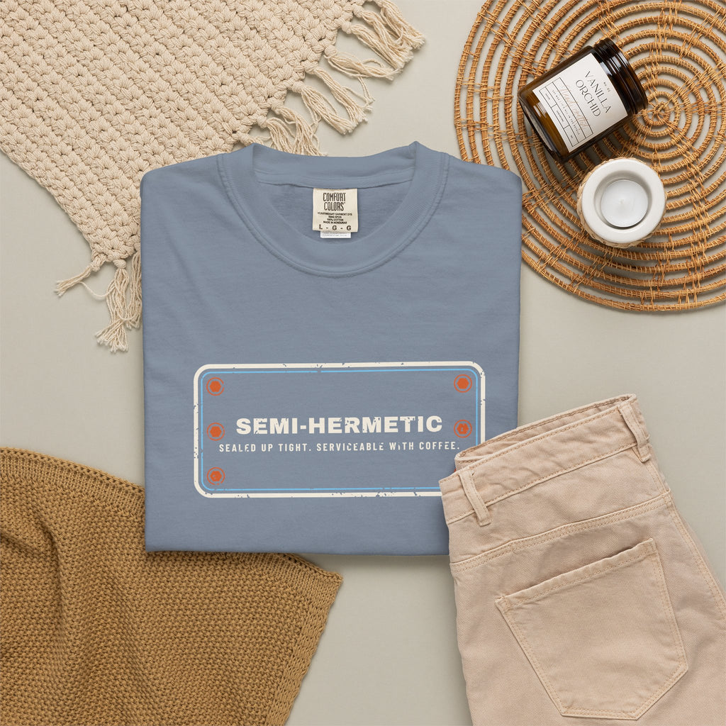 Blue Jean t-shirt flat-lay with SEMI-HERMETIC on a bolted cylinder head plate