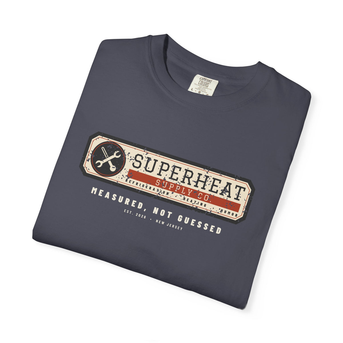 Folded navy t-shirt with a vintage equipment data plate reading Superheat Supply Co., Refrigeration Heating Humor