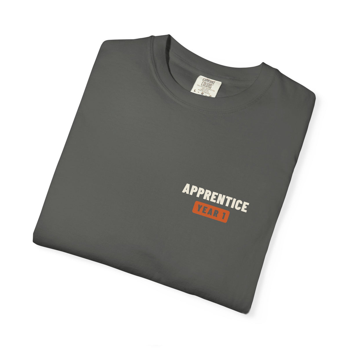 Folded Faded black t-shirt with a small Apprentice Year 1 tab on the left chest