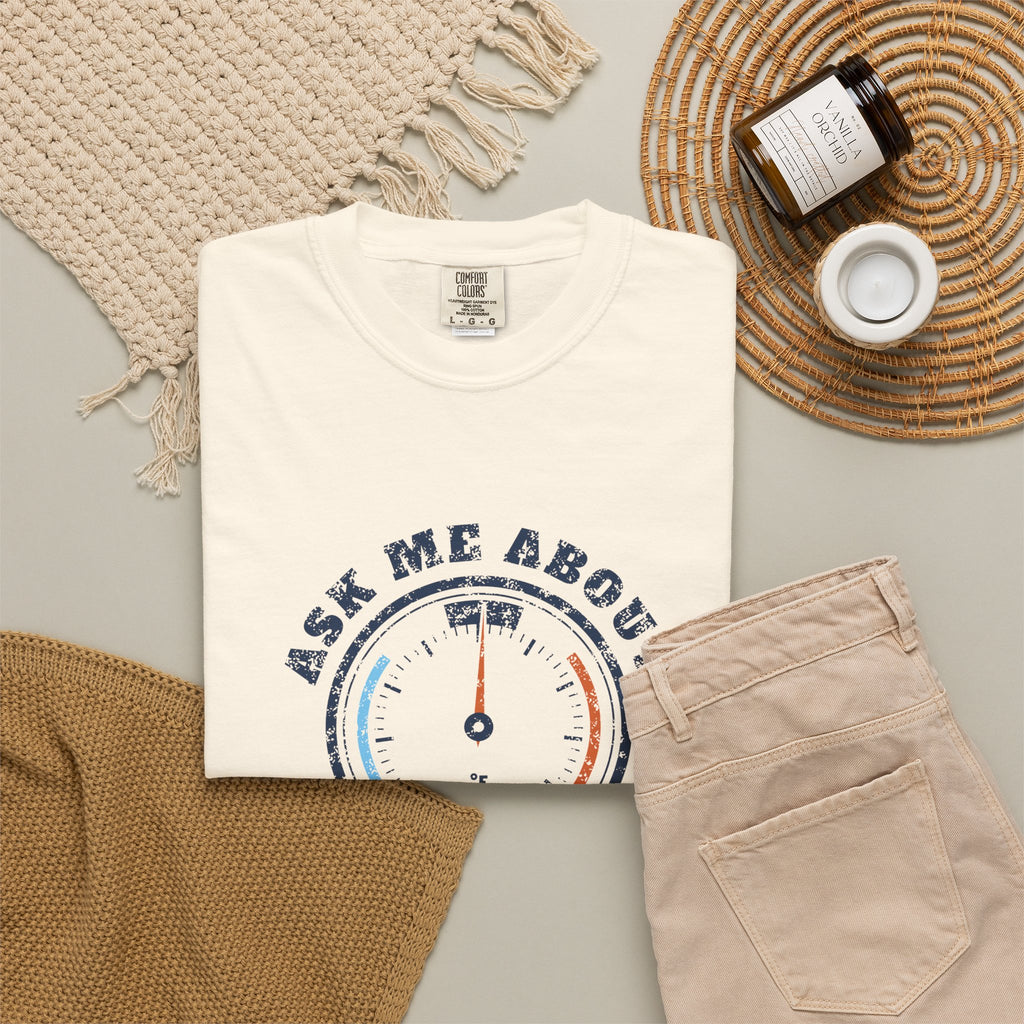 Folded ivory t-shirt with a retro gauge graphic and the words Ask Me About My Superheat across the chest