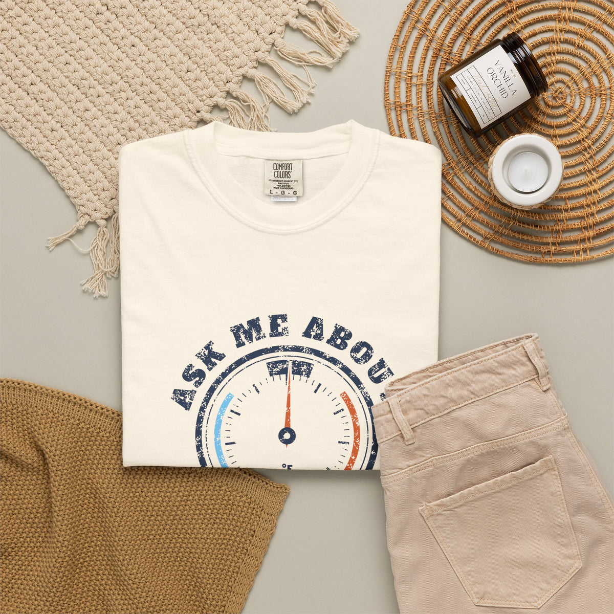 Folded ivory t-shirt with a retro gauge graphic and the words Ask Me About My Superheat across the chest