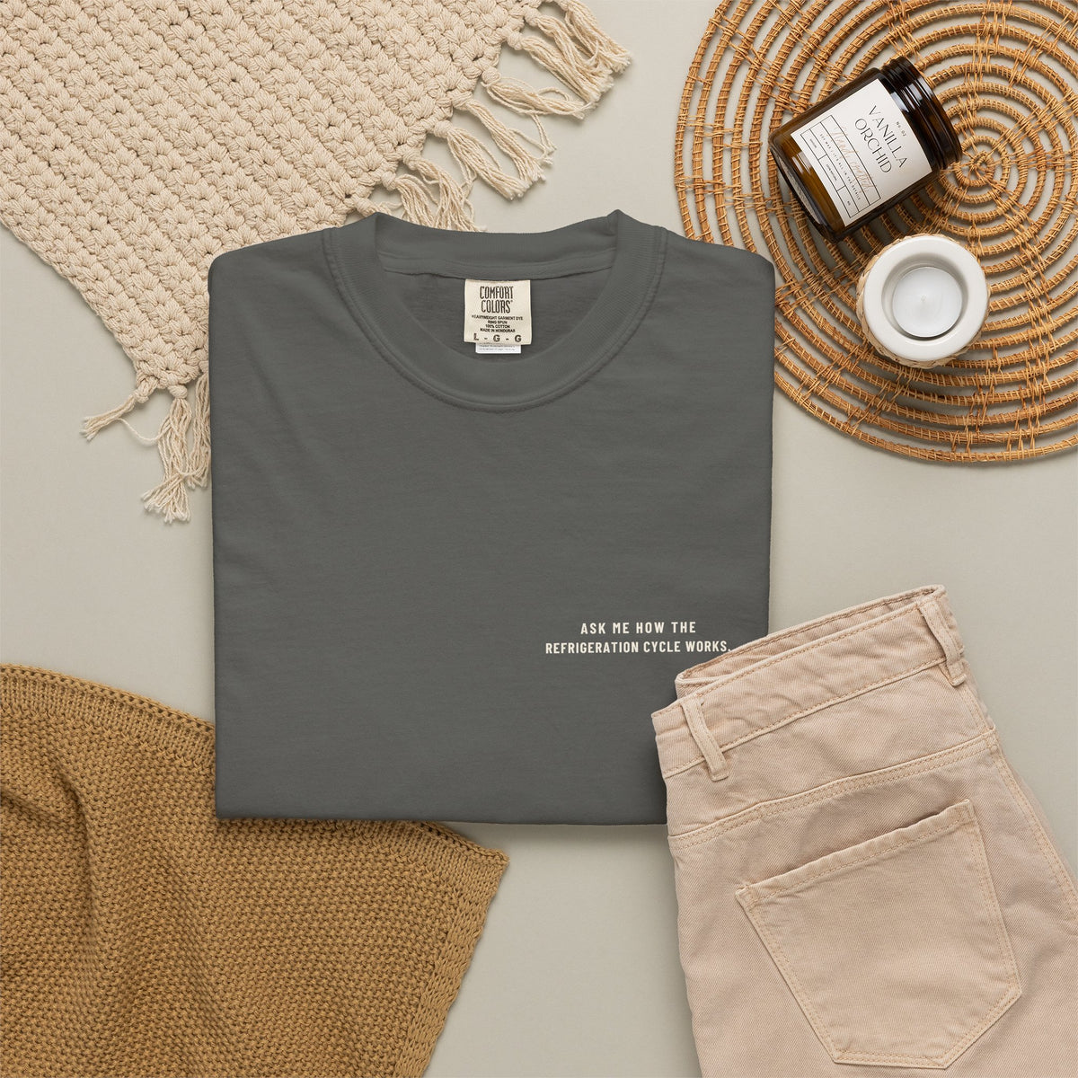 Faded black t-shirt flat-lay with Ask Me How the Refrigeration Cycle Works on the left chest