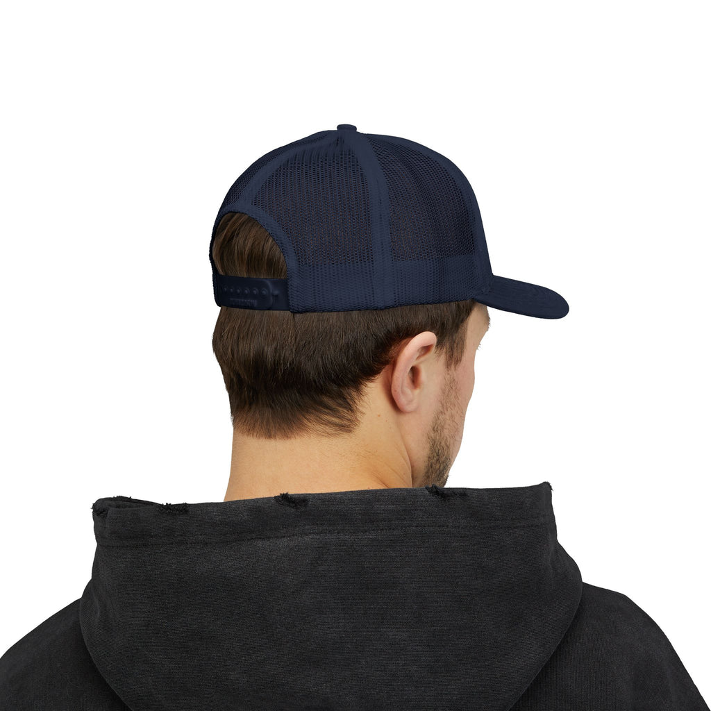 Person wearing the navy trucker hat, seen from the back with an adjustable snapback