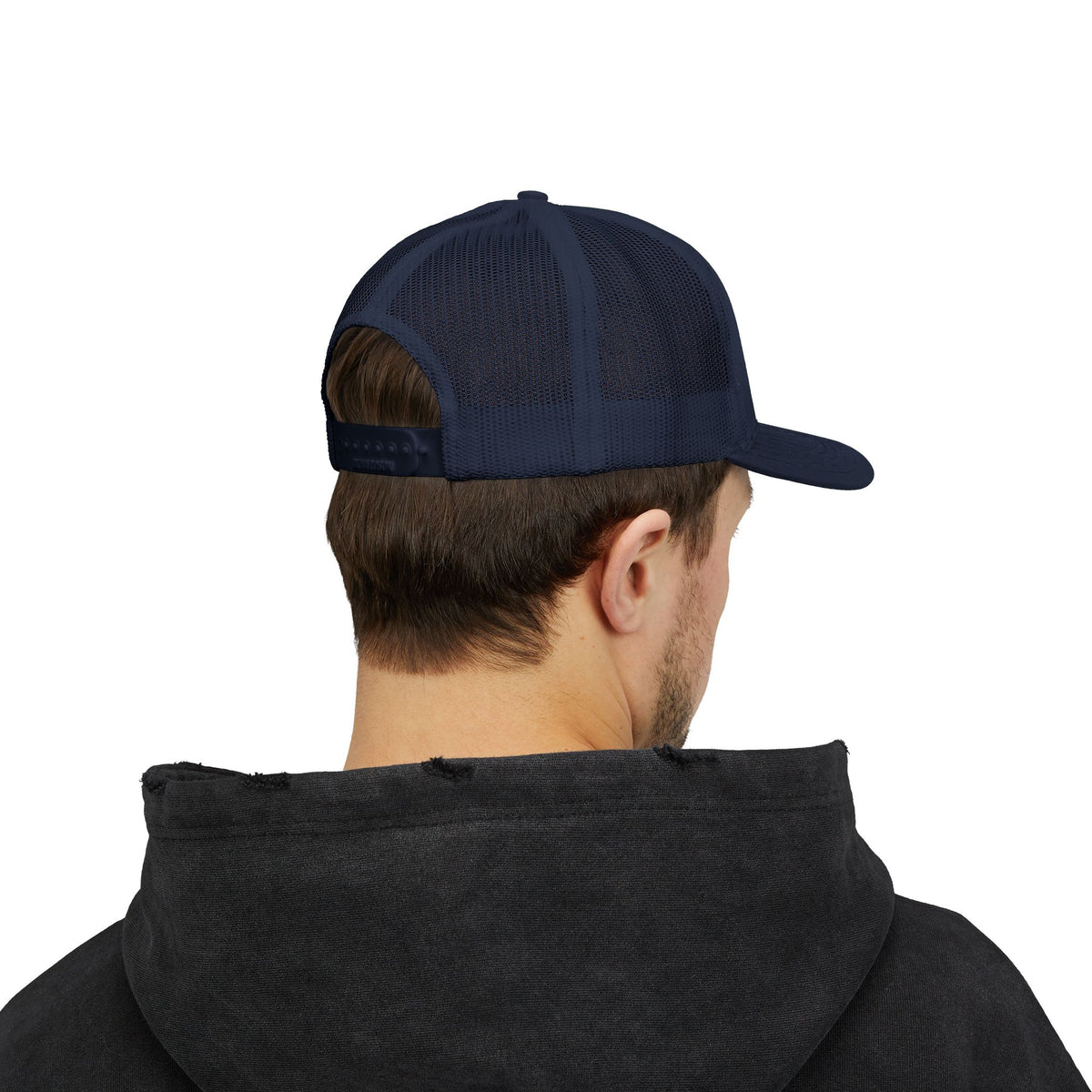 Person wearing the navy trucker hat, seen from the back with an adjustable snapback