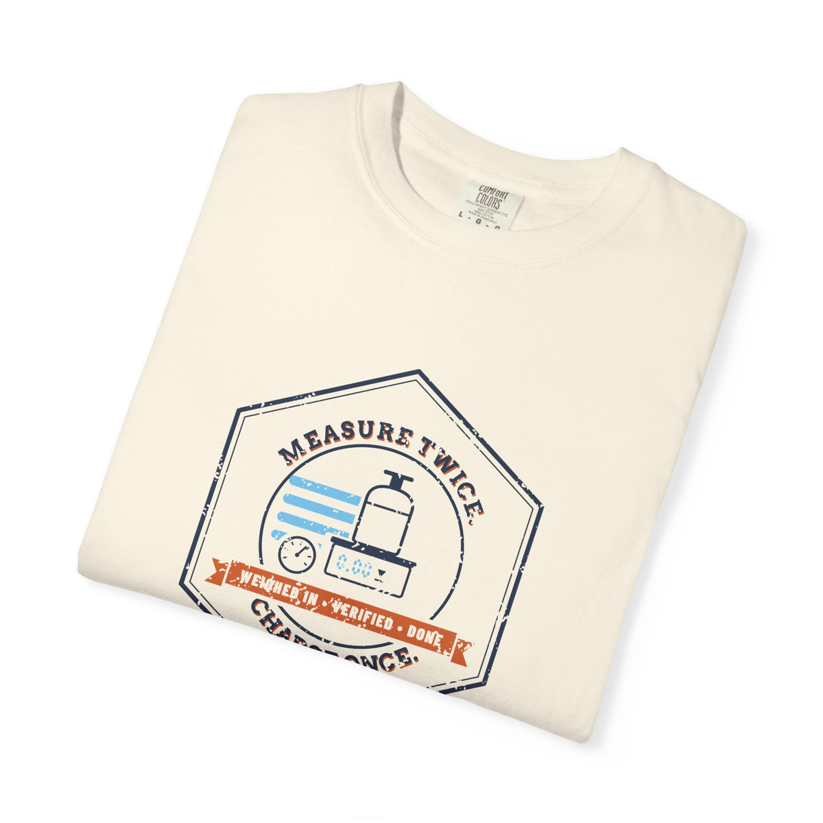 Folded Ivory t-shirt with a retro Measure Twice. Charge Once. hex badge with a cylinder on a scale