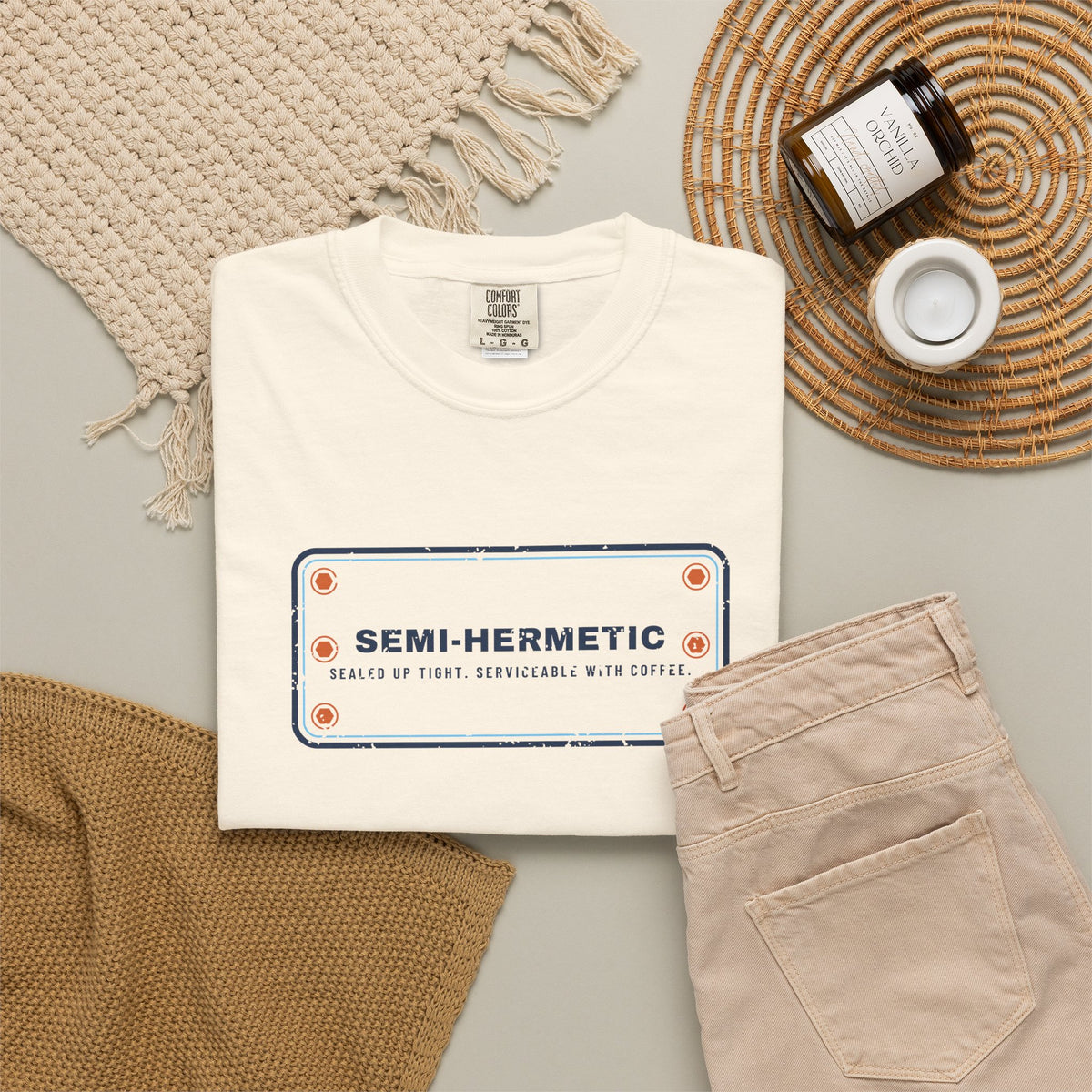 Ivory t-shirt flat-lay with SEMI-HERMETIC on a bolted cylinder head plate