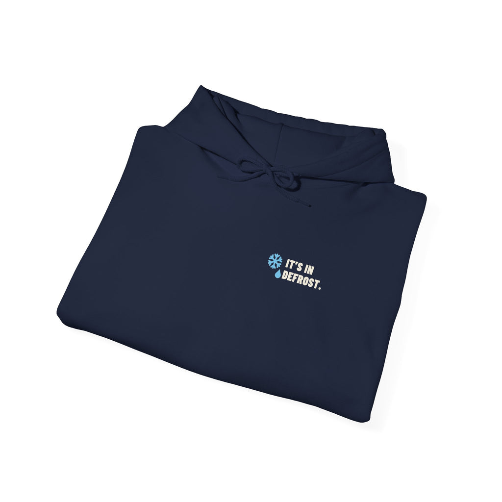 Folded Navy hoodie with a small It's In Defrost line on the left chest