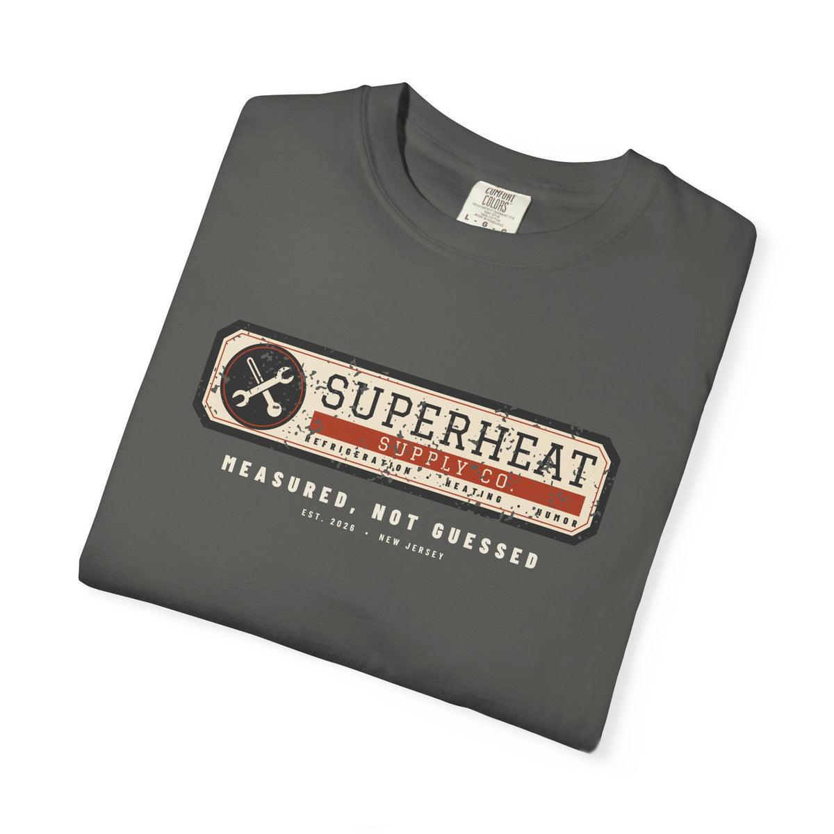 Folded faded black t-shirt with a vintage equipment data plate reading Superheat Supply Co., Refrigeration Heating Humor